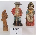 A pair of antique South American folk art carved wood figures decorated in polychrome colours,