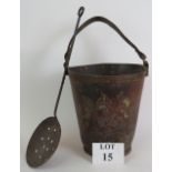 An antique leather fire bucket adorned with the Royal coat of arms.