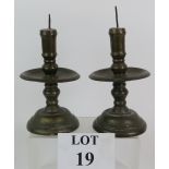 A pair of brass Dutch colonial candlesticks probably 17th Century of baluster form with large drip