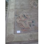 A large 20th century Chinese carpet, fawn & cream with dragons. 280cm x 380cm.