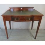 An Edwardian mahogany writing desk with inset tooled green leather writing surface,