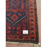 A 20th Century Persian rug on claret ground. 190cm x 103cm.