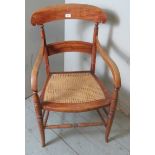 An antique fruitwood carver occasional chair with bergere seat,
