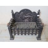 A cast iron fire basket with a decorative back panel depicting the Nations of Great Britain,