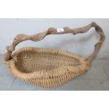 A handmade 'kindling' basket with a wisteria branch handle.