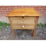 An antique pine child's desk with inset fielded panels to four sides,