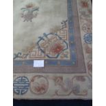 A large 20th century Chinese carpet on cream ground with blue border. 280cm x 380cm.