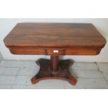 A Victorian rosewood turnover tea table with a tapering column pedestal,