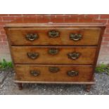 A George III mahogany chest of three long drawers fitted with fancy brass swan neck handles and