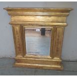 A square bevel edged wall mirror in a chunky gilt frame in the classical taste.
