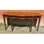 A large 19th century mahogany serpentine fronted serving table/sideboard with moulded frieze