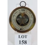 An antique brass wall aneroid barometer