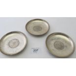 A collection of three silver dishes, all