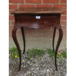 An antique mahogany work table with open