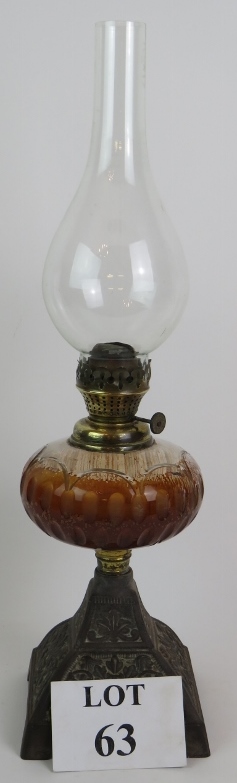 An antique oil lamp with cut glass reser