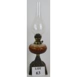 An antique oil lamp with cut glass reser