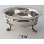 A silver bowl with wavy edge design and