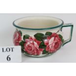 A late 19th Century Wemyss Ware pottery chamber pot hand decorated in cabbage rose pattern and
