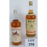 A litre bottle of Bells Whisky (marked duty free) and a litre bottle of Famous Grouse Scotch whisky,