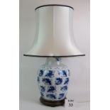 A 20th Century Chinese blue and white porcelain jar lamp decorated with multiple Koi Carp.