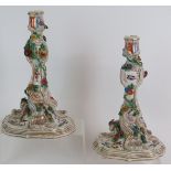 A pair of antique Meissen porcelain candlesticks with hand painted bird and insect decoration and