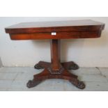 A Victorian rosewood turnover card table with a tapered hexagonal column raised on a quatreform