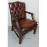 A Chesterfield button backed mahogany Gainsborough armchair upholstered in brown leather,