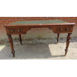 A 19th century mahogany writing desk with inset tooled green leather writing surface over two deep