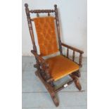A turn of the century American oak framed 'Dexter' child's rocking chair,