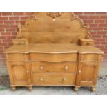 An antique pine Lancashire dresser, the shaped back decorated with carved cornice & finials,