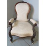 A Victorian open sided spoon backed show-wood mahogany framed armchair with carved cornice &