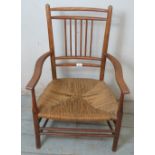 A 19th century elm & beech stick back carver chair with braided rope seat and give lower stretchers.