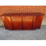 A large retro Danish serpentine fronted rosewood sideboard,