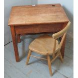 A solidly constructed golden oak vintage child's desk with lift up lid opening to reveal a storage