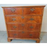 A Georgian walnut chest of two short over three long drawers fitted with fancy brass swan neck