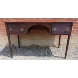 A George IV mahogany desk with an arched kneehole,