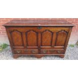 A large 19th century oak mule chest with double hinged lid opening to reveal internal candle box