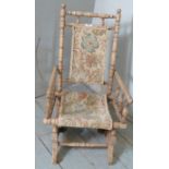 An Edwardian beech child's Dexter type rocking chair,