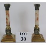 A pair of 19th Century classical revival Corinthian column brass candlesticks with white marble