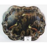 A 19th Century black lacquered papier mache tray with inset mother of pearl and gilt design