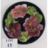 A Moorcroft pottery charger decorated with clematis pattern c1955,
