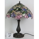 A good quality reproduction Tiffany style table lamp with floral stained glass shade and cast metal