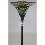 A Tiffany style up-lighter floor lamp with tulip decorated stained glass shade on a fluted column