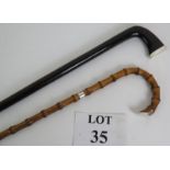 A high quality Edwardian silver mounted ebony or rosewood walking cane (91cm long) and a late