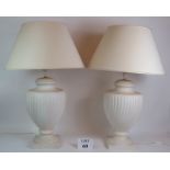 A pair of contemporary classical urn shaped ceramic lamps with matching shades. Base height: 54cm.