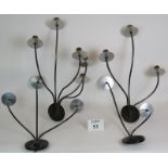 Four stylish steel and brass wall lights with varying sconces. (4). Largest: 68cm x 54cm.