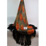 A vintage stylish black silk shawl with orange and gold flower decoration and 25cm long fringe.