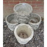 Three matching reconstituted stone garden planters in a free form textured mound and one other