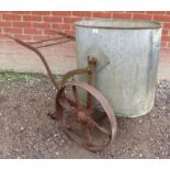 A galvanized steel water bowser mounted on a cast iron hand cart.