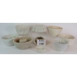 A collection of nine antique white porcelain jelly moulds including Copeland, Shelley & Wedgwood.
